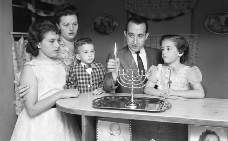 Josek Zajd lights a menorah with his family in a photograph that originally ran in the San Diego Union on Dec. 14, 1960. Josek and his wife, Sari, were Holocaust survivors and resettled in San Diego in 1954.