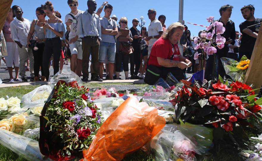 Flowers are laid out near the site of the truck attack in Nice. The attack ended when police shot and killed the driver.