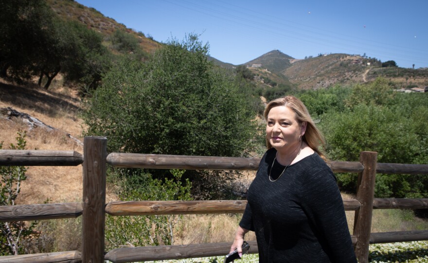 Susan Williams walks along a path in her housing development in Escondido, May 17, 2022.