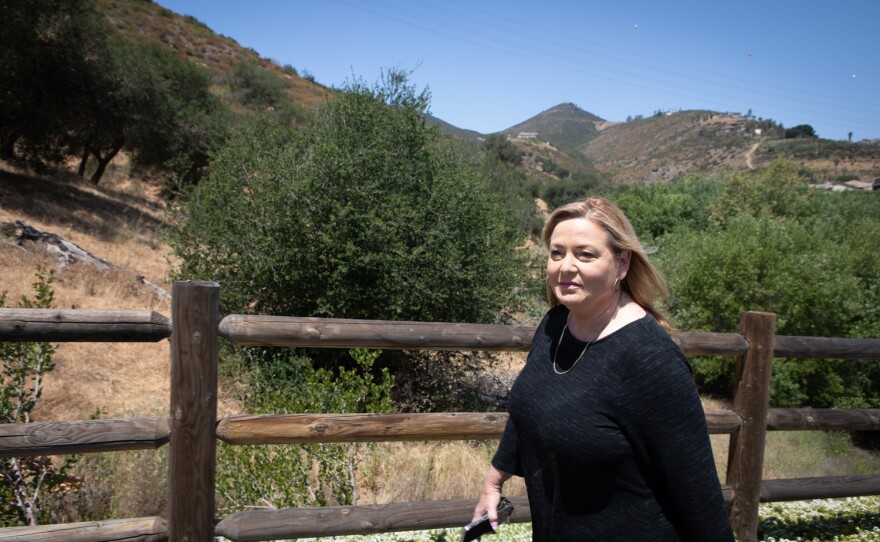 Susan Williams walks along a path in her housing development in Escondido, May 17, 2022. 