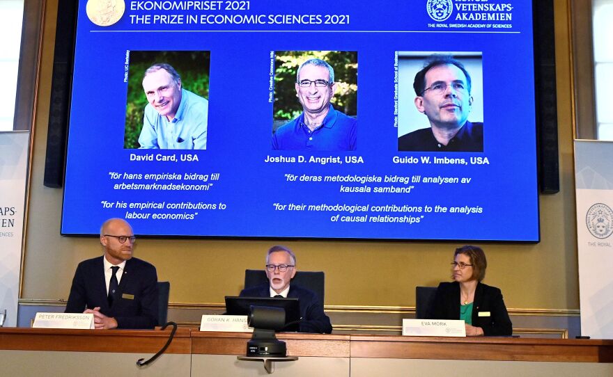 The Nobel Economics Prize committee members announce the winners of Nobel Memorial Prize in Economic Sciences on Monday. David Card, Joshua Angrist and Guido Imbens were given the award for their research of real-life events and policy changes.