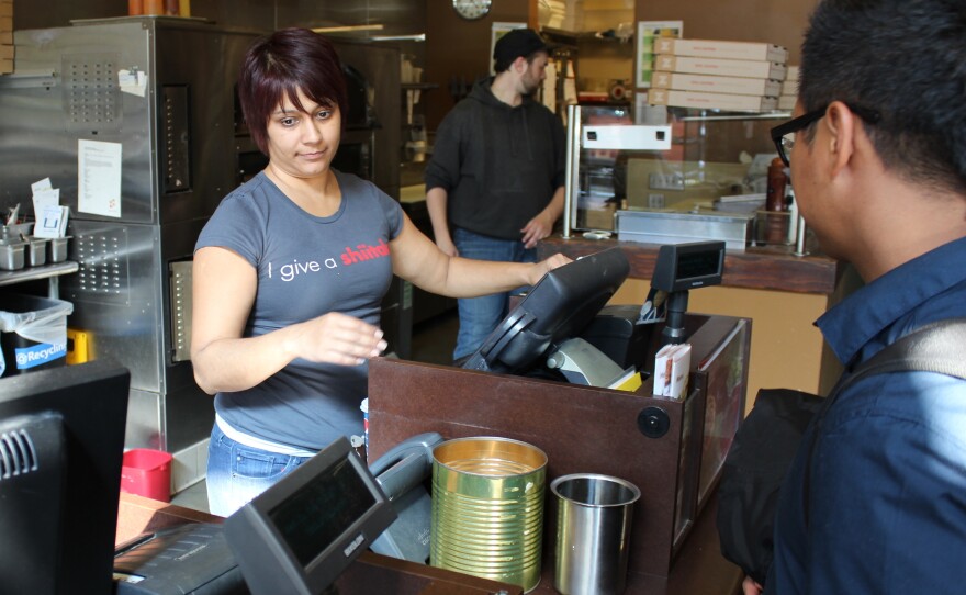 Ritu Shah Burnham owns a Z Pizza franchise in Seattle. She says she is closing her business because of the new minimum wage law, which mandates that she raise wages to $15 an hour by January 2017.