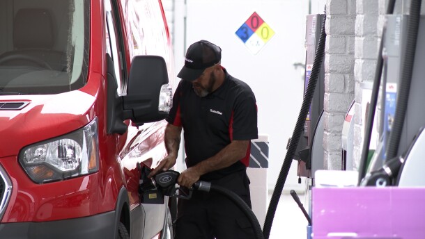 A deliver driver pumps gas at at a gas station on Park Boulevard in University Heights on March 31, 2026.