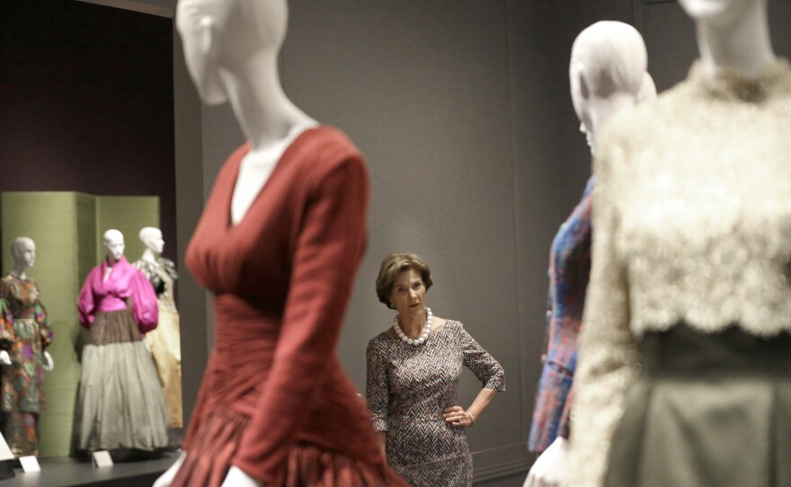 Former first lady Laura Bush with Oscar de la Renta outfits on display in Dallas in July for a retrospective on the designer's career at the George W. Bush Library and Museum.