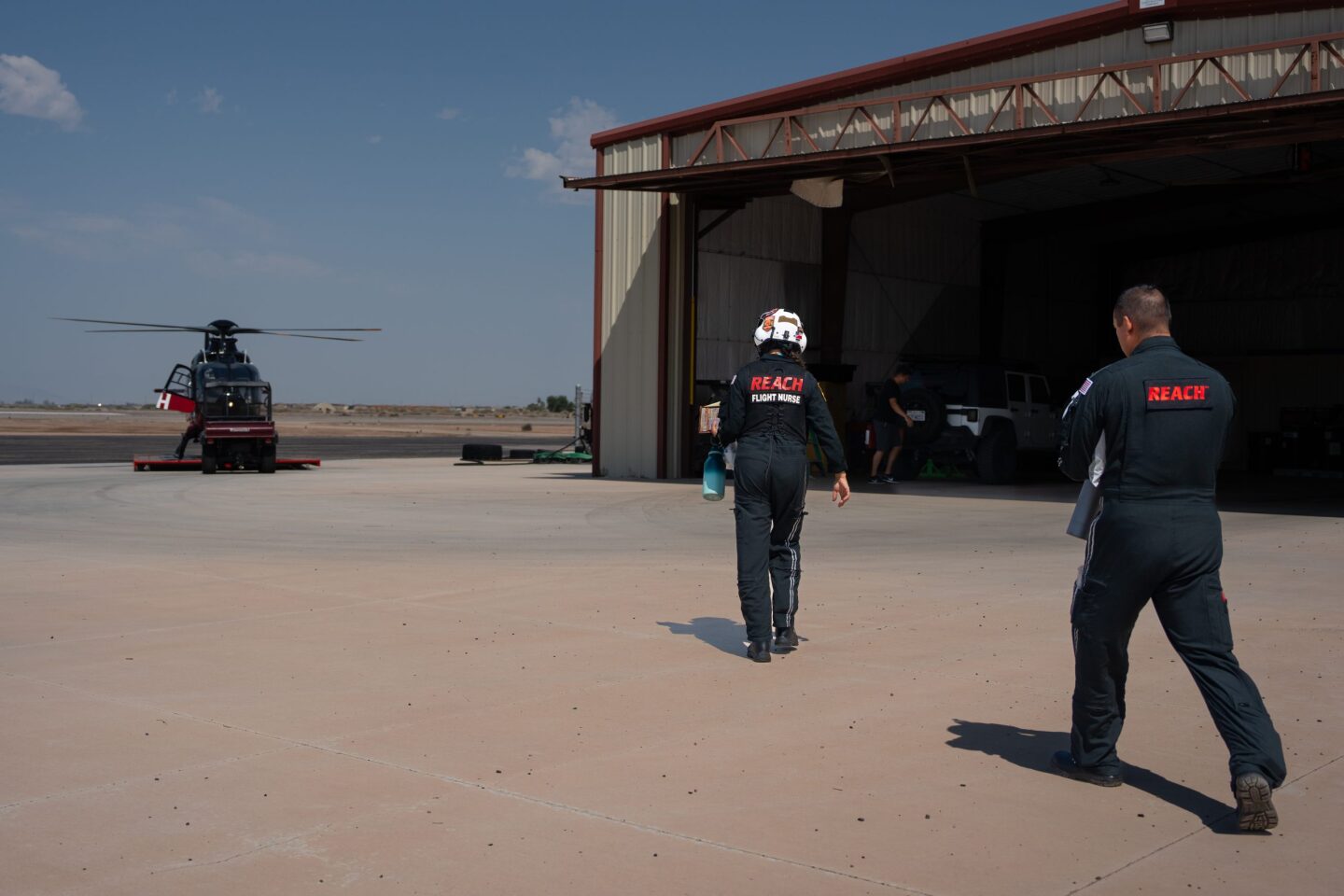 Helicopter ambulance nurses cross tarmac toward the helicopter for a 911 call on July 10, 2024. 