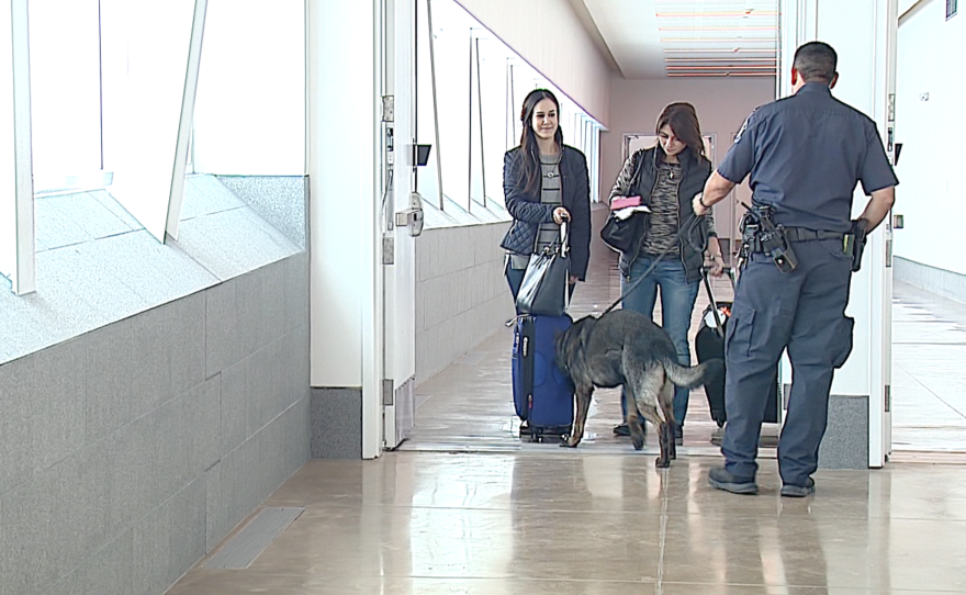 Two passengers walk out of the Cross Border Xpress, Dec. 9, 2015.