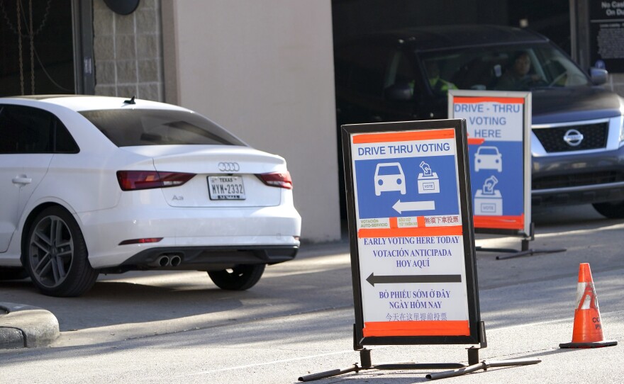 Cars enter and leave a drive-thru voting site in Houston on Election Day in 2020. Texas Republican lawmakers are looking to ban the practice.