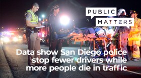 In this Aug. 21, 2014 image from video, firefighters and police work the scene of a fatal single-car traffic accident in which three Japanese college students were killed and five other foreign students injured when the car carrying them veered off the road and struck a power pole on State Route 78 in Oceanside.