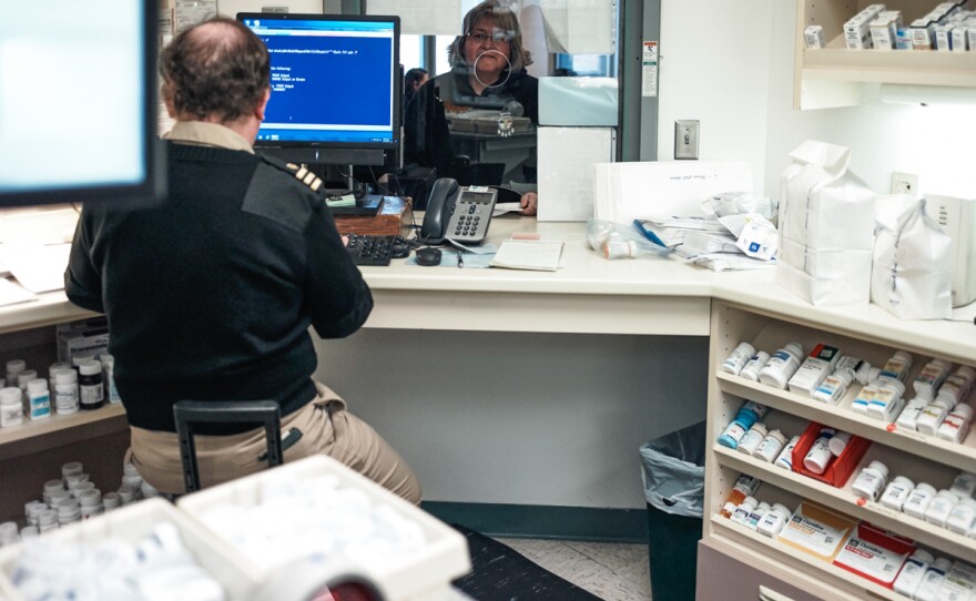 Hoff picks up prescriptions at the Indian Health Service clinic in Wagner. The pharmacy staff member is part of the U.S. Public Health Service Commissioned Corps.