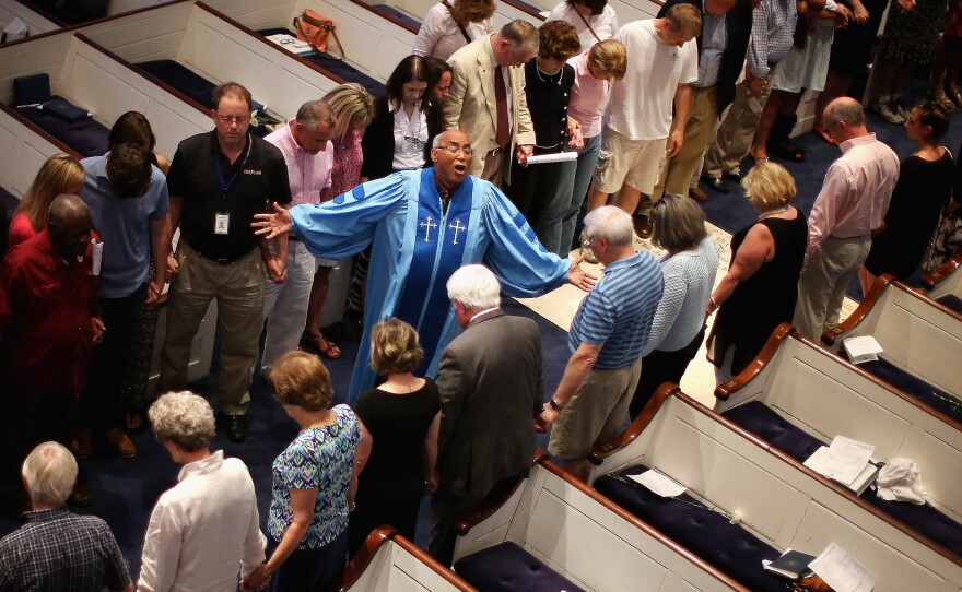 The Rev. Sidney Davis leads mourners at Charleston's Second Presbyterian Church during a community prayer service for the nine victims of the shooting at the historic Emanuel AME Church.