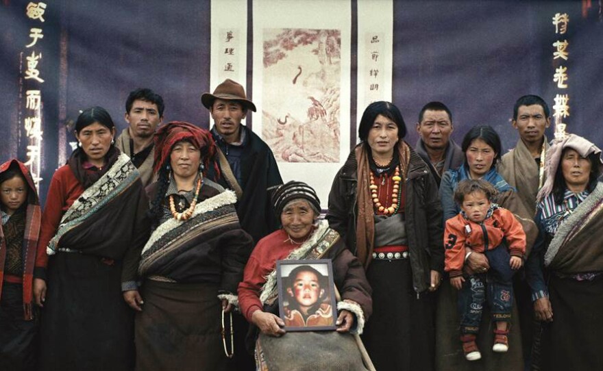 A family of Tibetan nomads — they're real, not actors — poses before an Asian backdrop in a new fictional short film.
