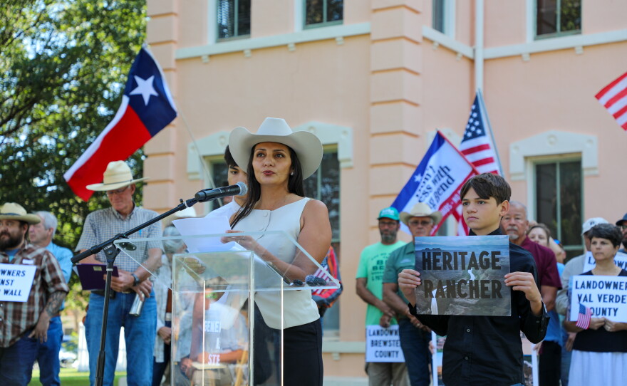 Yolanda Alvarado, a fifth-generation cattle rancher in west Texas, stands with her sons at a press conference on Monday in Marfa, announcing a landowner lawsuit against a proposed border wall along the border with Mexico.