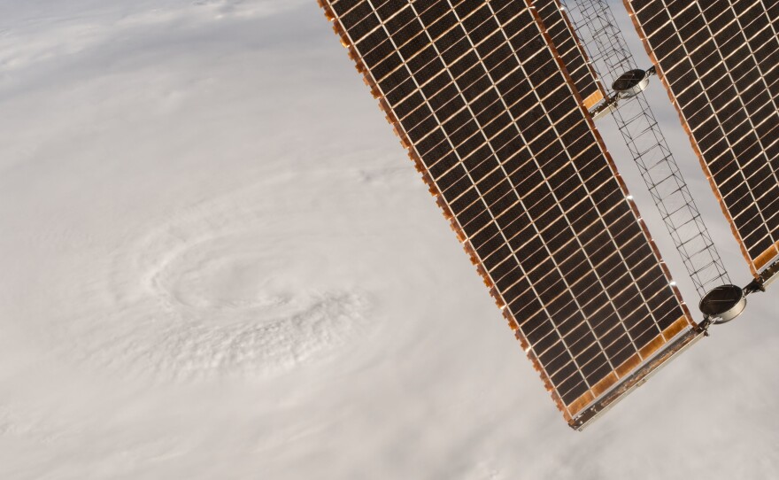 A photo taken Tuesday shows Hurricane Matthew as seen from the International Space Station; Expedition 49 Flight Engineer Kate Rubins took the photo; the space station's solar arrays are at top right.
