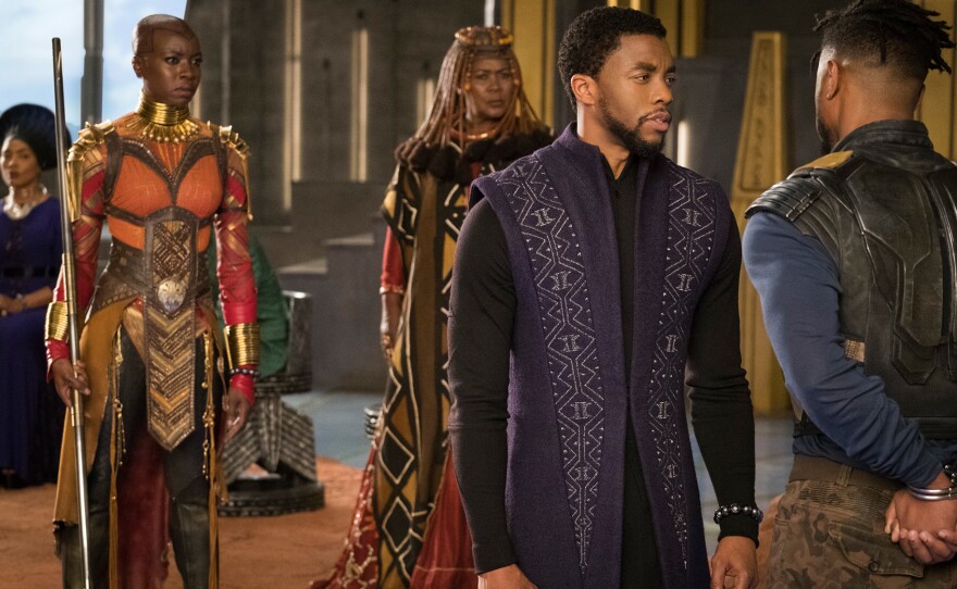 A scene from Black Panther. The titular hero, played by Chadwick Boseman, is on the right.