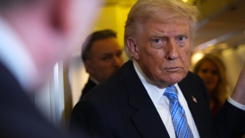 President Donald Trump speaks to reporters aboard Air Force One, Friday, May 15, 2026, as he returns from a trip to Beijing, China.