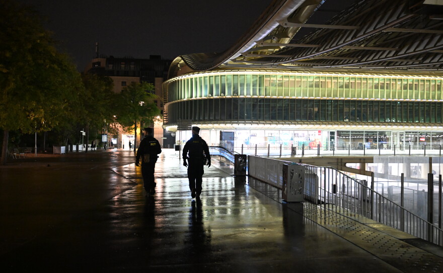 Policemen patrol during an overnight curfew in Paris, Tuesday, Oct. 20, 2026.
