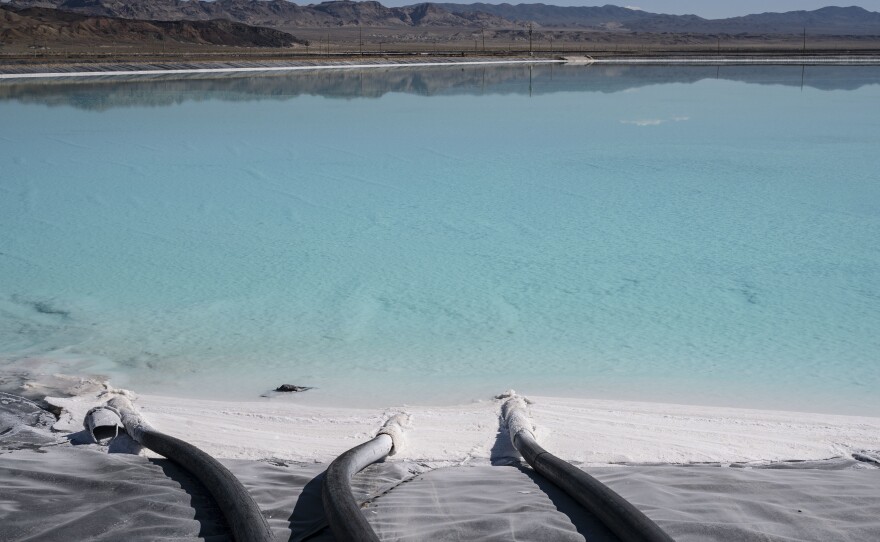 Tubes enter a lithium brine evaporation pool at Silver Peak lithium mine in Silver Peak, Nev. on Oct. 6, 2022.