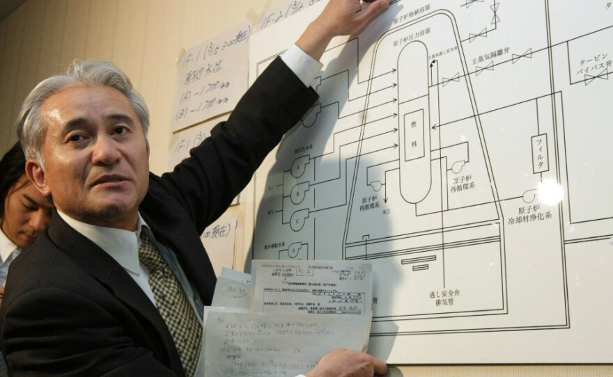 A nuclear plant specialist with the Tokyo Electric Power Co. explains the structure of a nuclear reactor at the company's Fukushima power plant during a news conference Tuesday.