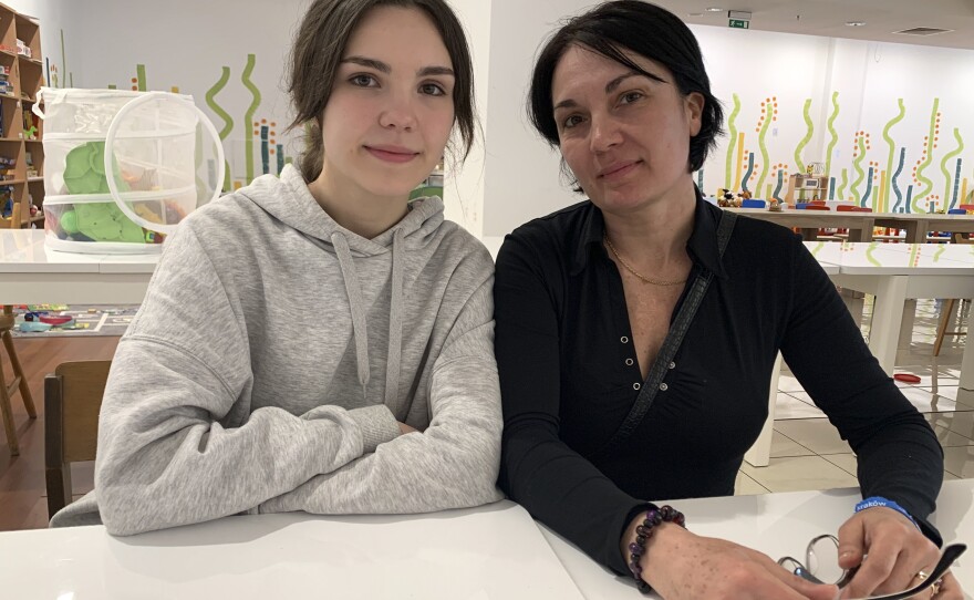 Galia Alacheva and her mother Sara Tarashchanska sit together in a pop-up lunchroom in an abandoned mall that has been converted into a shelter for Ukrainian refugees.