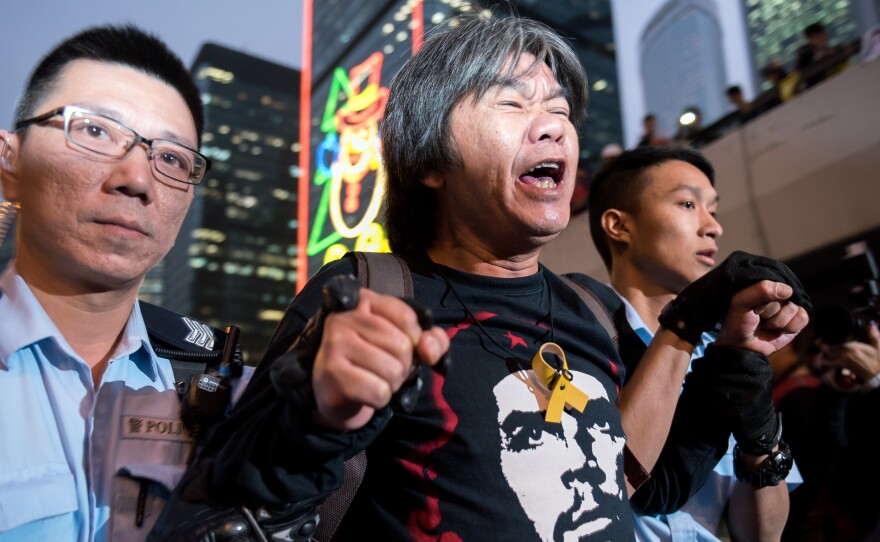 Hong Kong police arrest lawmaker and pro-democracy activist Leung Kwok-Hung during a sit-in as police clear the main protest site in the Admiralty district in Hong Kong on Thursday.