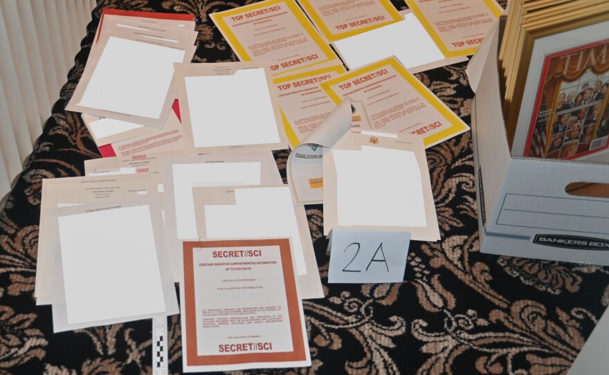 This image contained in a court filing by the Department of Justice, and partially redacted by the source, shows documents seized during the Aug. 8 FBI search of former President Donald Trump's Mar-a-Lago estate.