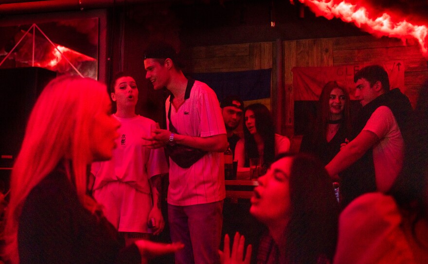 People talk and sing loudly as the party gets underway.