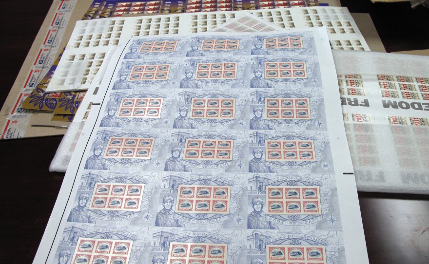 Postmaster General Patrick Donahoe owns every stamp printed since 1892. This box contains sheets of reprinted vintage stamps.