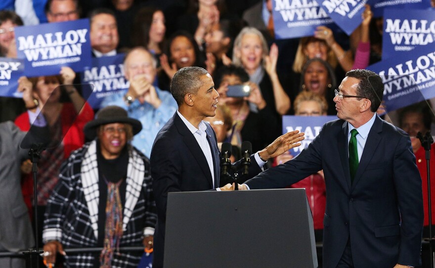 President Barack Obama stands with Connecticut Governor Dan Malloy in Bridgeport on Sunday. Malloy is in a tough re-election battle with Republican Tom Foley. The president spent the weekend trying to energize the Democratic base to get out and vote in Tuesday's middterm elections.