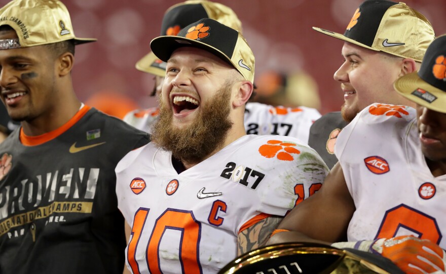 Clemson Tigers linebacker Ben Boulware, center, celebrates after his team defeated the Alabama Crimson Tide 35-31 to win the 2017 College Football Playoff National Championship Game.
