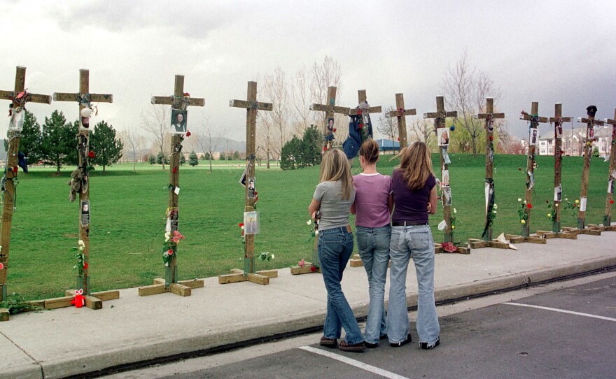 On the two-year anniversary of the Columbine High School massacre, students stand before a memorial for the 13 people killed.