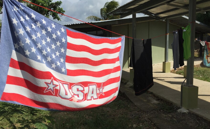 An American flag towel dries at the shelter for Cuban migrants in La Cruz, Costa Rica. U.S. officials say they have no intention of changing laws that generally allow Cubans who reach American soil to stay, but those fleeing the island are doubtful.