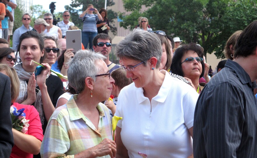 Gail Stockman, 60, left and Beth Black, 58, of Albuquerque, N.M., are shown with other same-sex couples preparing to marry at a massive wedding in Albuquerque Civic Plaza on Tuesday Aug. 27, 2013.