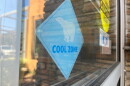 A sign that says "Cool Zone" hangs in the window of the San Marcos Library on July 31, 2026.