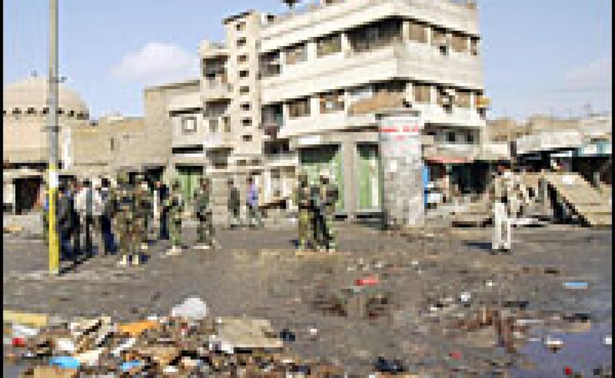 Iraqi troops secure a market in central Baghdad, the site of one of the Feb. 1 suicide attacks.