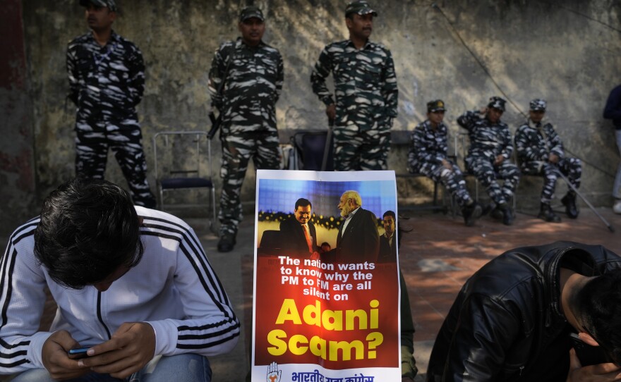 Members of opposition Congress party, demanding an investigation into allegations of fraud and stock manipulation by India's Adani Group, display a placard with images of Indian businessman Gautam Adani and Indian Prime Minister Narendra Modi during a protest in New Delhi, Feb.6.