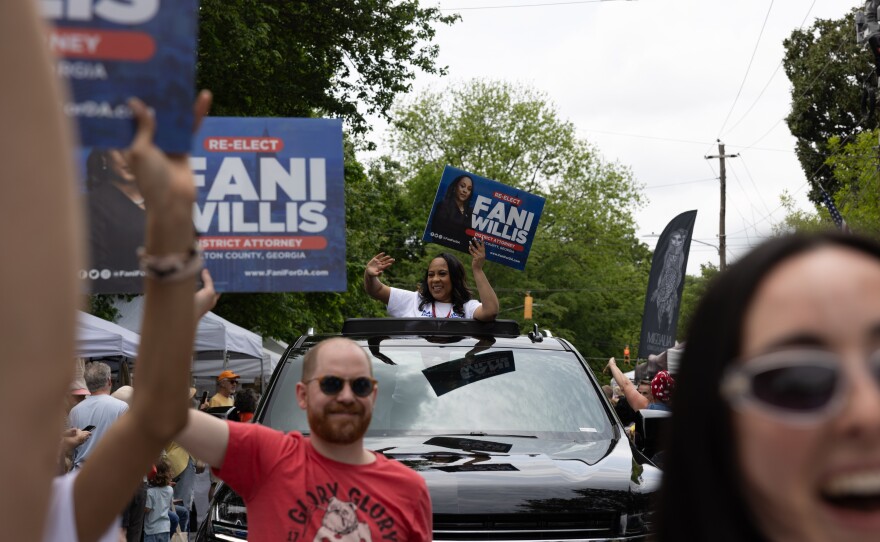 Fulton County District Attorney Fani Willis, a Democrat who's also up for reelection this month, is seen riding in an SUV at a parade in Atlanta on April 27. Willis regularly receives death threats, especially since she asked a grand jury to indict former President Donald Trump and his allies.