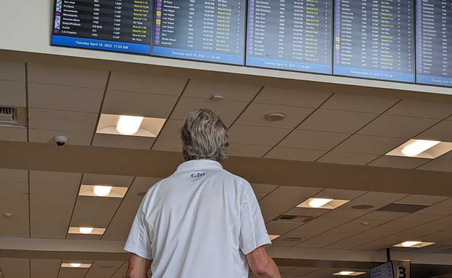A person looks at a flight information display system at San Diego International Airport. San Diego, Calif. April 18, 2023.