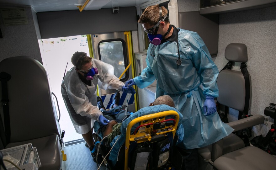 Medics transport a man with COVID-19 symptoms to a hospital in Austin, Texas. More than 3 million people in the state have had COVID-19, but just 81,000 are listed in a central data set at the Centers for Disease Control and Prevention.