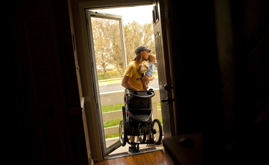 Jonathan juggles Zane and a stroller while rushing to pick up Egan at the neighborhood bus stop. Being the only stay-at-home father in the neighborhood was initially isolating, but he found men in similar situations through a local Yahoo group.