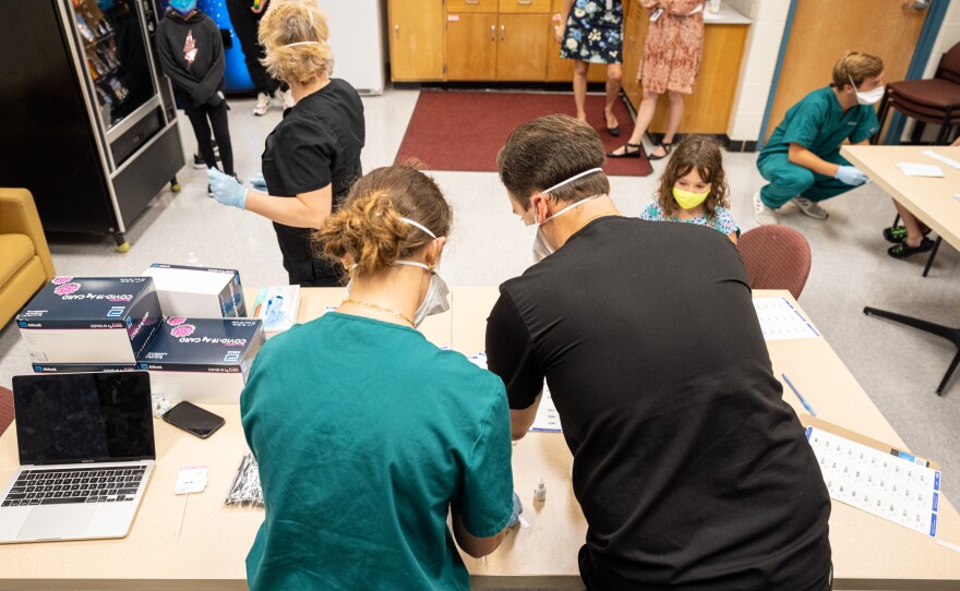 Nurses work at a COVID-19 testing day for students and school faculty at Brandeis Elementary School on in Louisville, Ky.