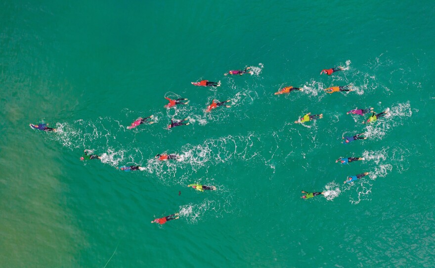 Las Truchas, an open-water women's swimming group formed in Peru during the height of the COVID-19 pandemic, is seen the the Pacific wearing colors of the rainbow to symbolize peace and love.