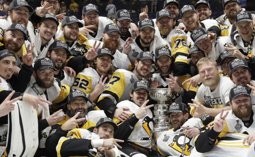 Pittsburgh Penguins players celebrate Sunday after defeating the Nashville Predators 2-0 in Game 6 of the NHL Stanley Cup Final in Nashville, Tenn.