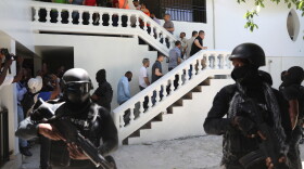 FILE - Colombians and Haitians who are accused of involvement in the 2021 assassination of Haitian President Jovenel Moise are escorted in handcuffs to their court hearing in Port-au-Prince, Haiti, May 26, 2025.