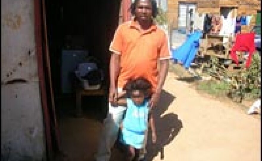 Mbuyiselo Innocent Klass, head of the Mabuye Land Rights Forum, a group trying to get land rights, and his four-year-old daughter Gugu at home in Zolani.
