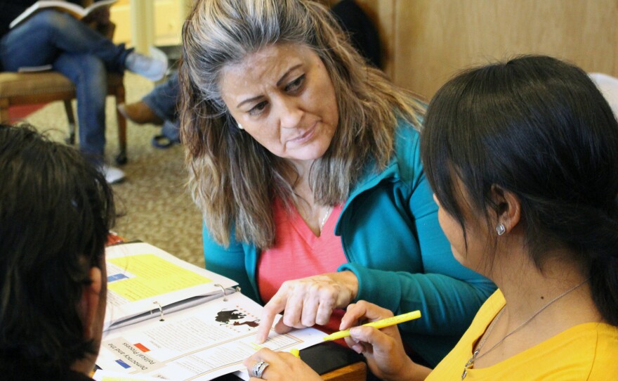Student Gabriela Cardenas, left, asks a question of citizenship class instructor Marissa Velazquez at the Brush, Colo., public library.