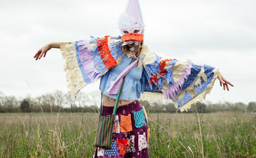 A Mardi Gras dressed in traditional sloth scraps and handmade mask to hide their identity.