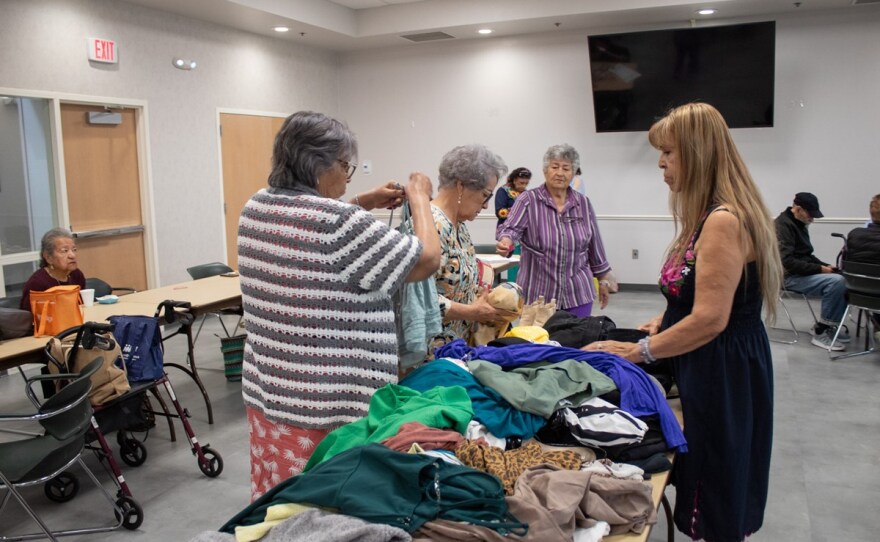 People go through a pile of gently worn clothing other Manitos members donated Friday, May 23, 2025, at the Sam & Bonnie Pannell Community Center in Sacramento.