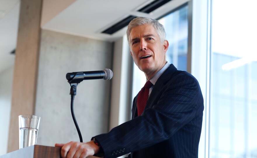 Judge Neil Gorsuch of the 10th U.S. Circuit Court of Appeals   makes a point while delivering prepared remarks before a group of attorneys last Friday at a luncheon in a legal firm in lower downtown Denver.
