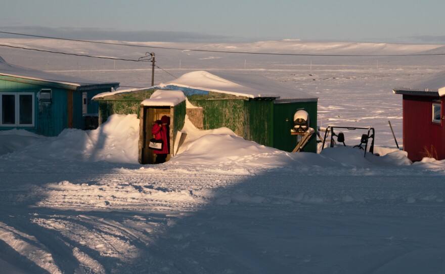 A census worker goes door to door in January to count some of Alaska's most remote residents in Toksook Bay. Warming temperatures and thawing permafrost are making it harder to get an accurate count for the 2020 census in some Alaska Native villages.