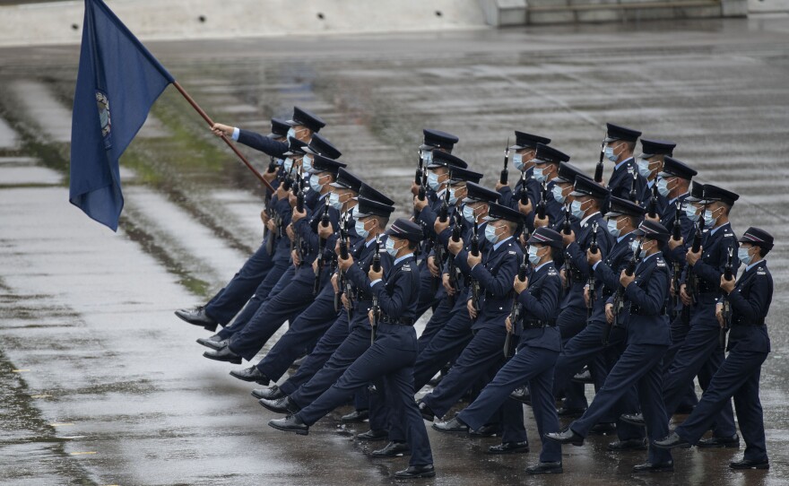 Hong Kong police show their new goose step marching style on National Security Education Day at a police school in Hong Kong on April 15.